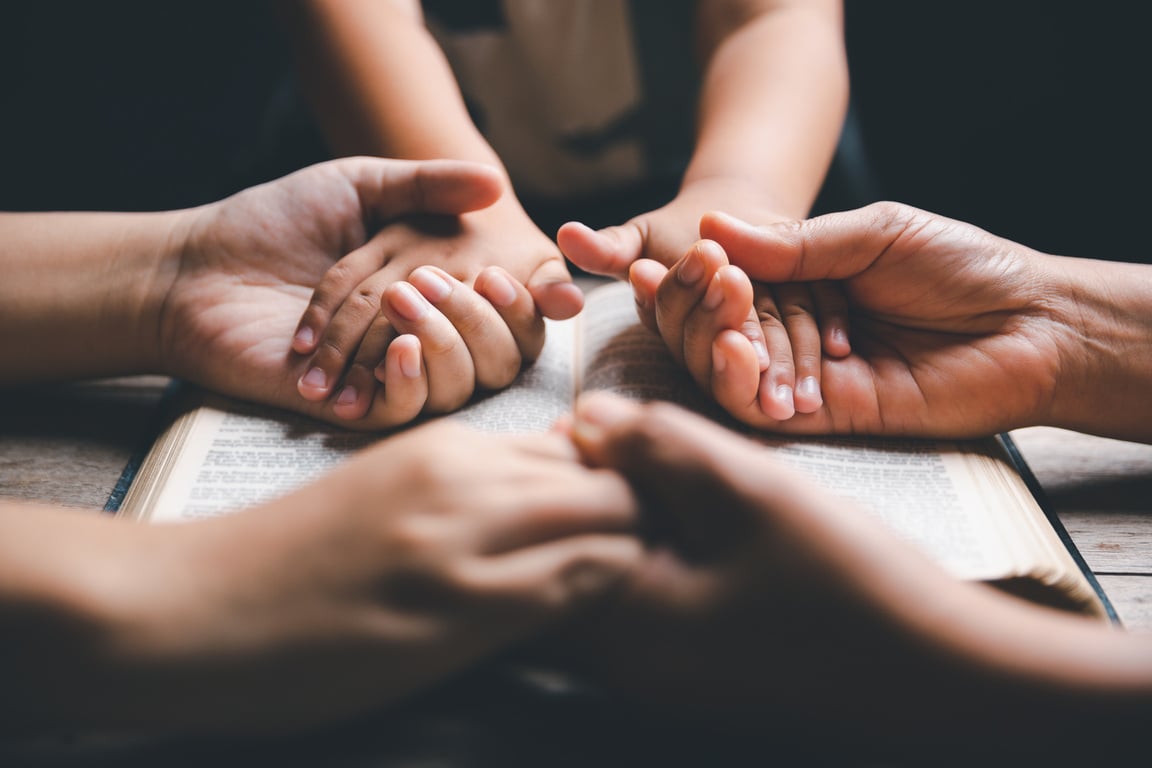 praying at home. Asian christian with little boy and teen girl praying together.